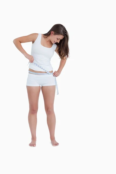Smiling woman looking at her waist — Stock Photo, Image
