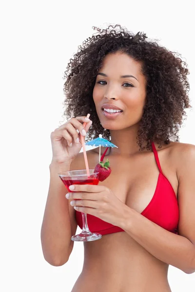 Attractive brunette holding a fruit cocktail — Stock Photo, Image