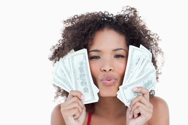 Young attractive woman puckering her lips while holding bank not — Stock Photo, Image