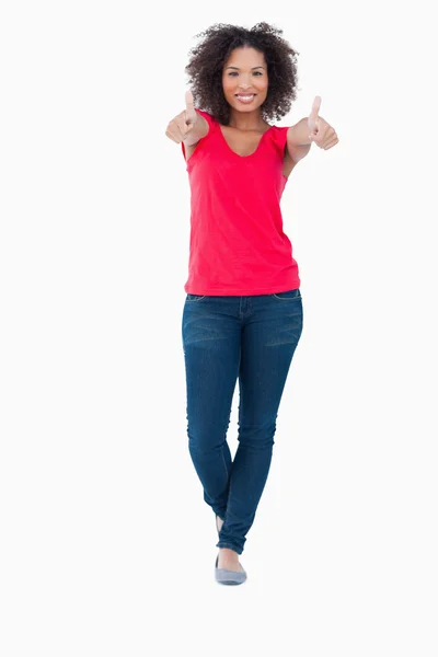 Smiling woman placing her thumbs up in satisfaction — Stock Photo, Image