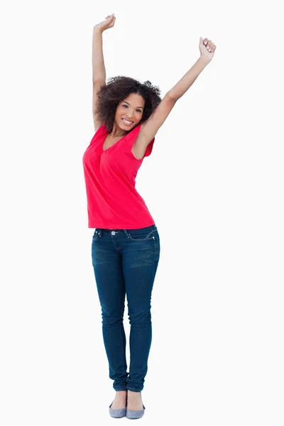 Happy young brunette raising her arms above her head — Stock Photo, Image