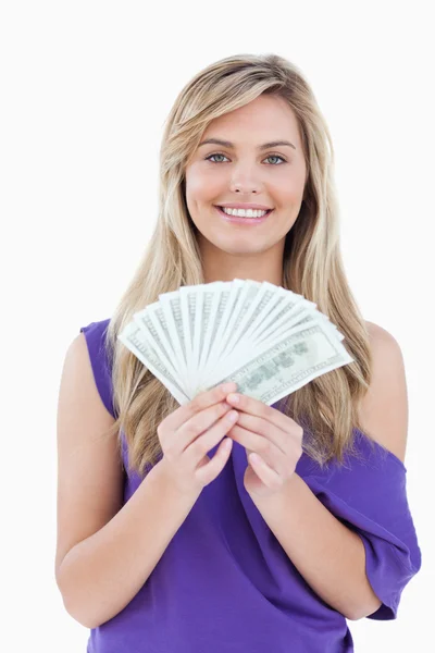 Happy blonde woman holding a fan of notes — Stock Photo, Image