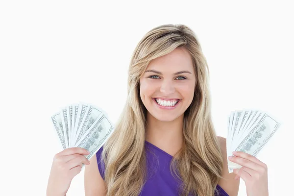 Happy blonde woman holding two fans of notes — Stock Photo, Image