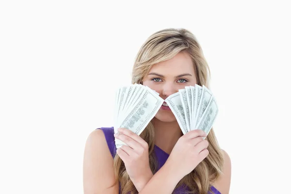 Young blonde woman holding two fans of notes — Stock Photo, Image