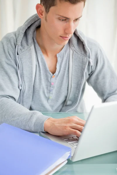 Close-up of a student using a laptop — Stock Photo, Image