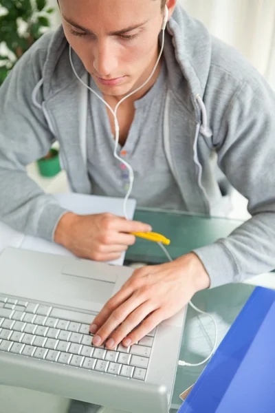 High-angle view of a student doing his homework while helping wi — Stock Photo, Image