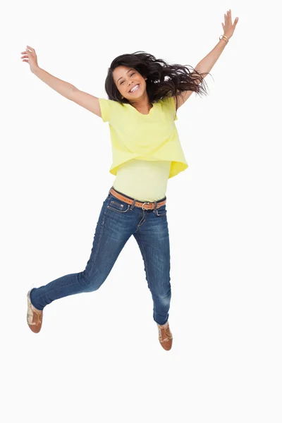 Smiling Latin student jumping — Stock Photo, Image