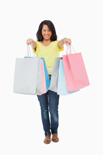 Beautiful Latin student showing her shopping bags — Stock Photo, Image