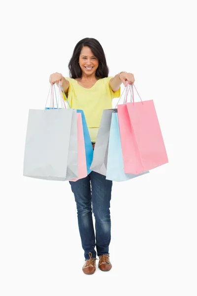 Pretty Latin student showing her shopping bags — Stock Photo, Image