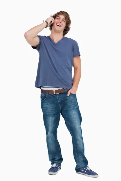 Standing male student laughing while calling — Stock Photo, Image