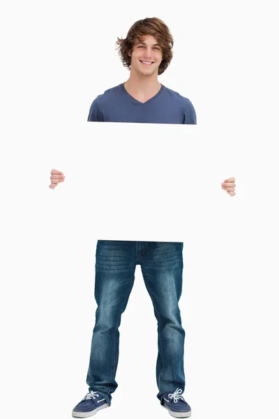 Male student holding a white board — Stock Photo, Image