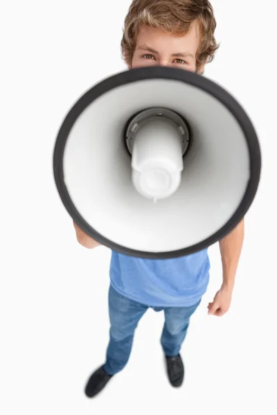 Fisheye view of a male student speaking in a megaphone — Stock Photo, Image