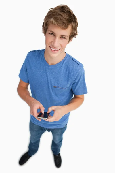 Fisheye view of a male student holding a smartphone — Stock Photo, Image