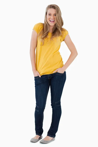 Smiling young woman posing hands in the pockets — Stock Photo, Image