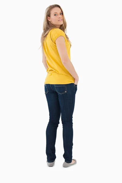 Back view of a young woman posing hands in the pockets — Stock Photo, Image