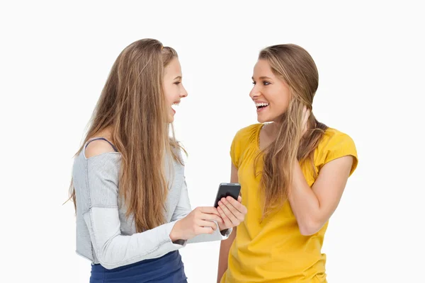 stock image Two surprised young women holding a smartphone