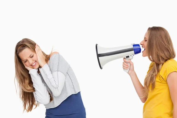 Blonde student using a loudspeaker on a other girl — Stock Photo, Image