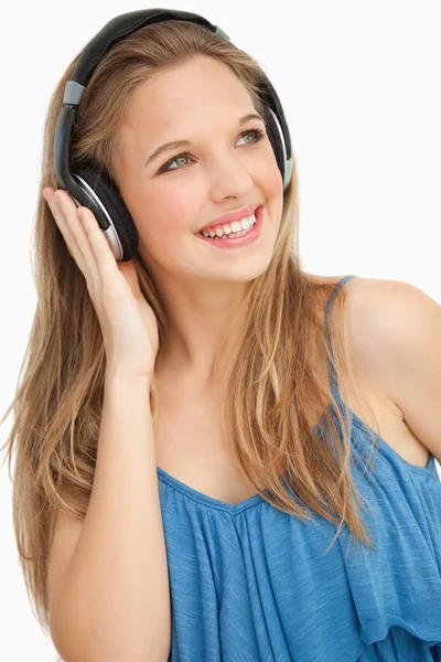 Close-up of a beautiful young woman wearing headphones — Stock Photo, Image