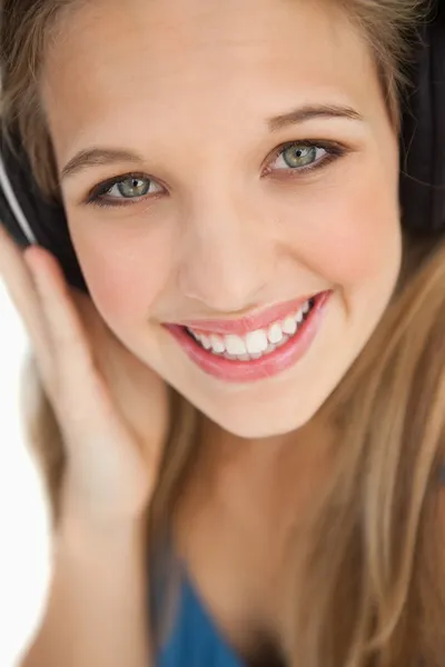 Close-up of a cute young blonde wearing headphones — Stock Photo, Image