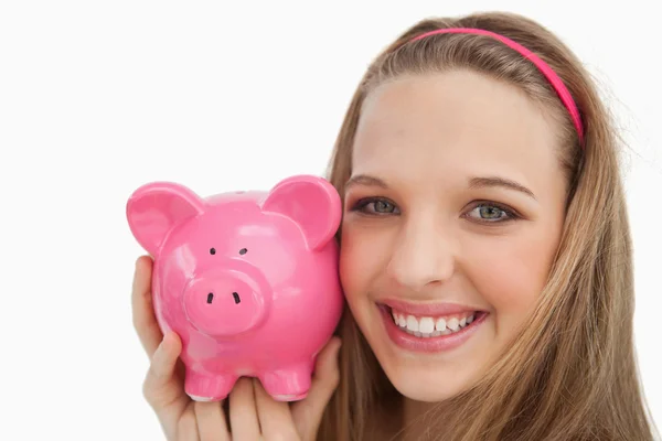 Close-up of a young woman holding a piggy-bank — Stock Photo, Image