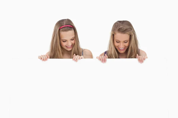 Close-up of two young women holding a blank board — Stock Photo, Image