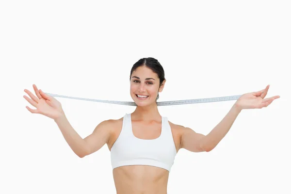 Smiling slim woman with a measure tape — Stock Photo, Image