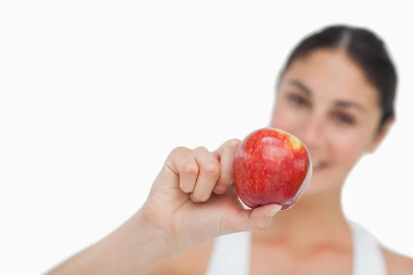 Close-up on a apple holding by a brunette — Stock Photo, Image
