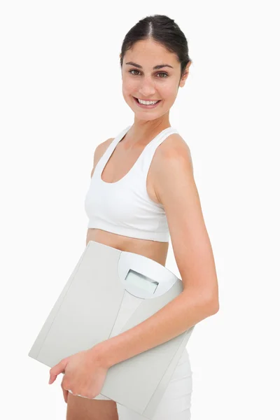 Portrait of a slim young woman holding a scales — Stock Photo, Image