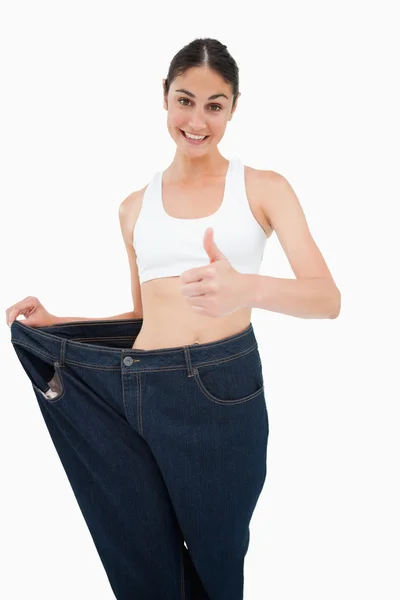 Smiling woman who lost a lot of weight the thumb-up — Stock Photo, Image