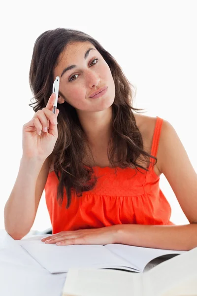 Thoughtful student doing her homework — Stock Photo, Image