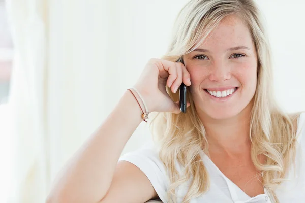Από κοντά shot μιας γυναίκας που είναι χαμογελώντας ως αυτή συνομιλίες στο τηλέφωνό της — Φωτογραφία Αρχείου