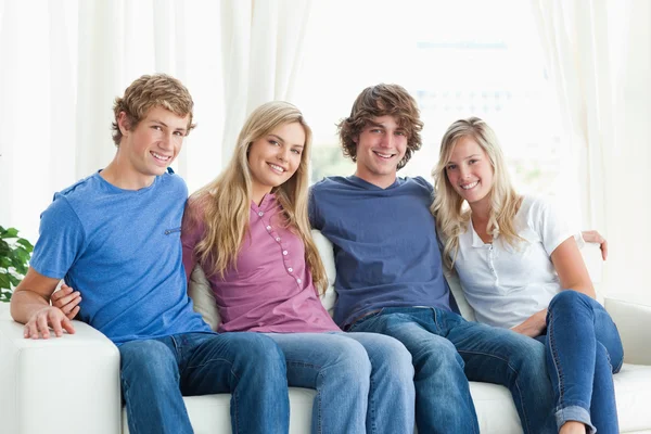 Friends holding each other as they look at the camera — Stock Photo, Image
