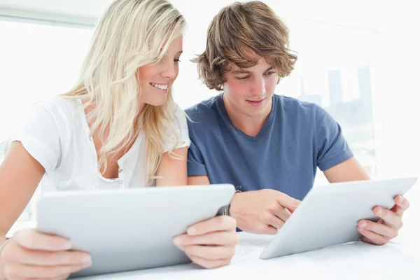 A couple both using tablets — Stock Photo, Image
