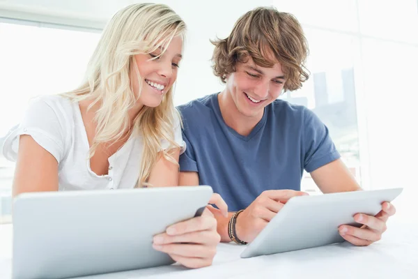 A man and woman both using their tablets — Stock Photo, Image