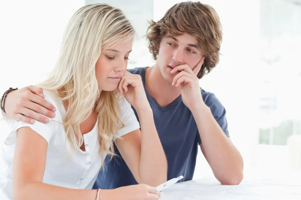A couple looking worried as the girl holds a pregnancy test — Stock Photo, Image