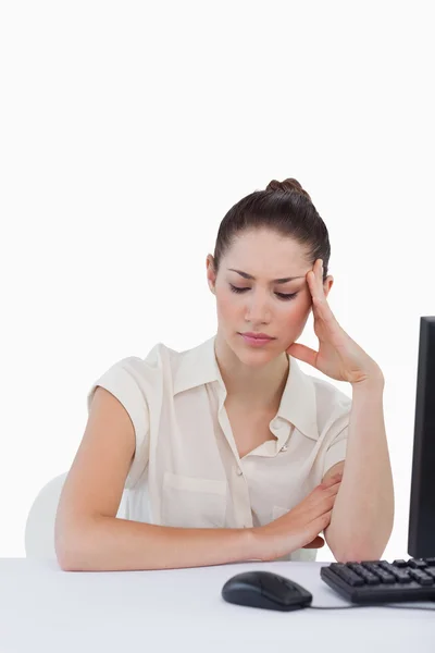 Portrait of a tired secretary using a computer — Stock Photo, Image