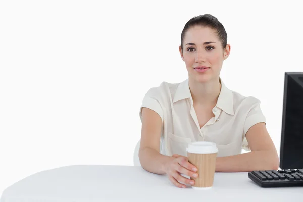 Donna d'affari che beve un caffè da asporto mentre utilizza un computer — Foto Stock