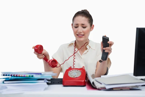 Stressed businesswoman answering the phones — Stock Photo, Image