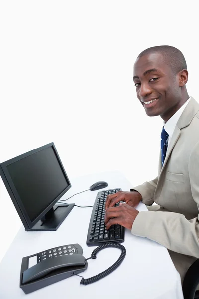 Widok z boku uśmiechający się biznesmena za pomocą komputera — Zdjęcie stockowe