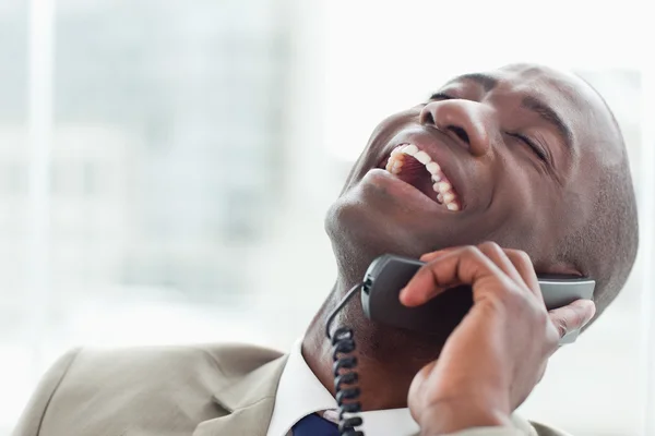 Close up of a delighted businessman on the phone — Stock Photo, Image