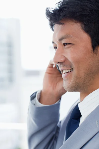 Portret van een glimlachende kantoor werknemer op de telefoon — Stockfoto
