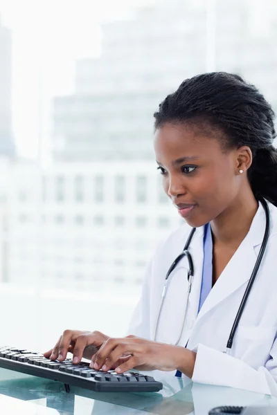 Portrait of a serious female doctor using a computer — Stock Photo, Image