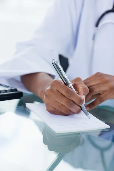Feminine hand writing a prescription — Stock Photo, Image