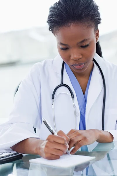 Portrait of a female doctor writing a prescription — Stock Photo, Image