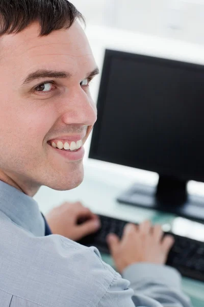 Visão traseira de um empresário sorridente usando um monitor — Fotografia de Stock