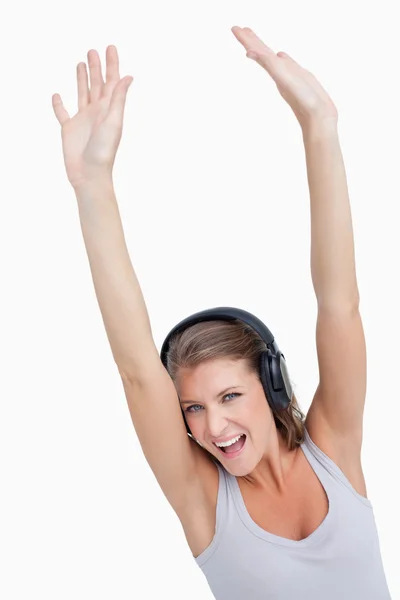 Portrait of a beautiful woman dancing while listening to music — Stock Photo, Image