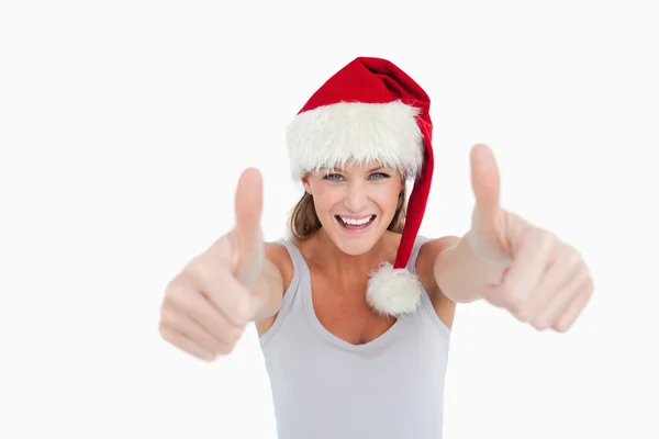 Kobieta z kciuki i kapelusz Boże Narodzenie — Zdjęcie stockowe