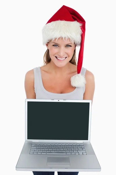 Woman with a Christmas hat showing a notebook — Stock Photo, Image