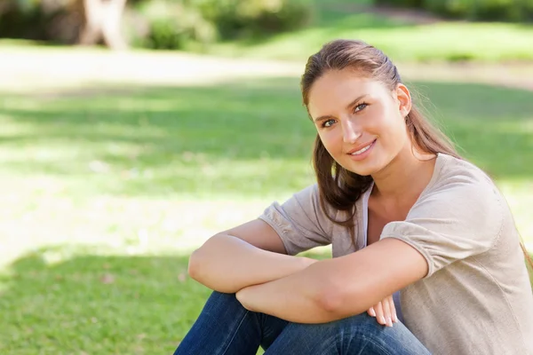 Smiling woman relaxing in the park Stock Picture