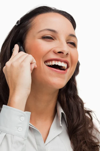 Close-up of a brunette beaming while calling — Stock Photo, Image